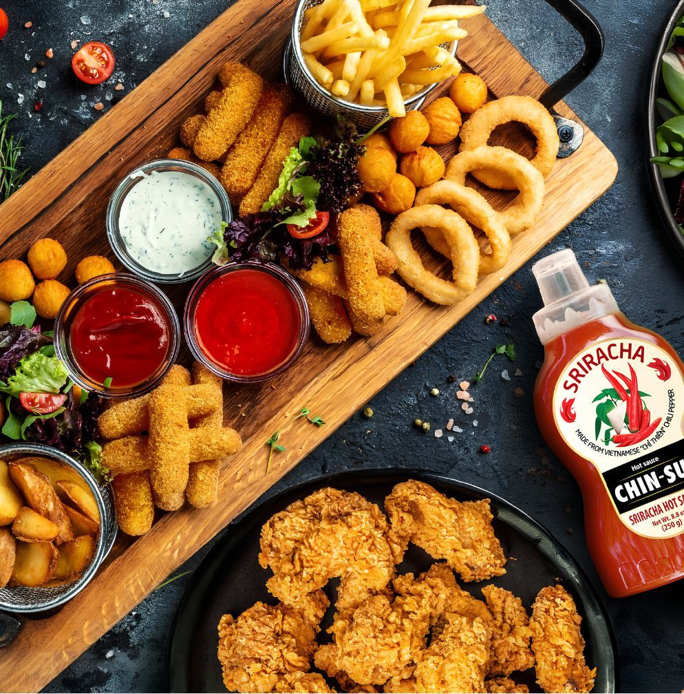 chin-su sriracha hot sauce with fried food