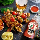 chin-su sriracha hot sauce with grilled skewers